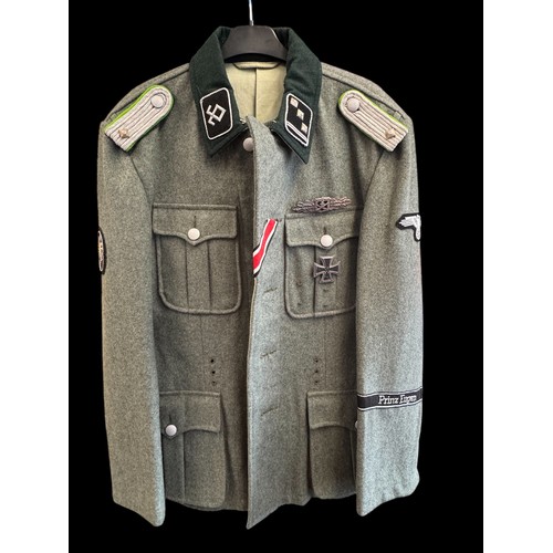 65 - A reproduction SS Officer's Tunic with badges and insignia. 44