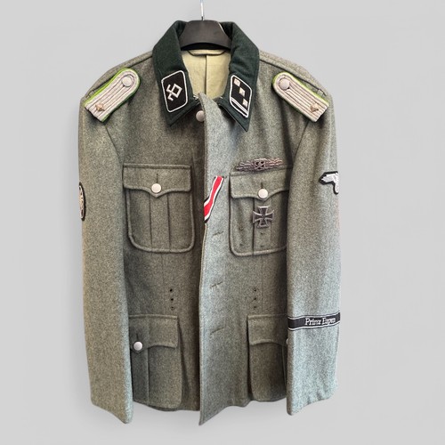 65 - A reproduction SS Officer's Tunic with badges and insignia. 44