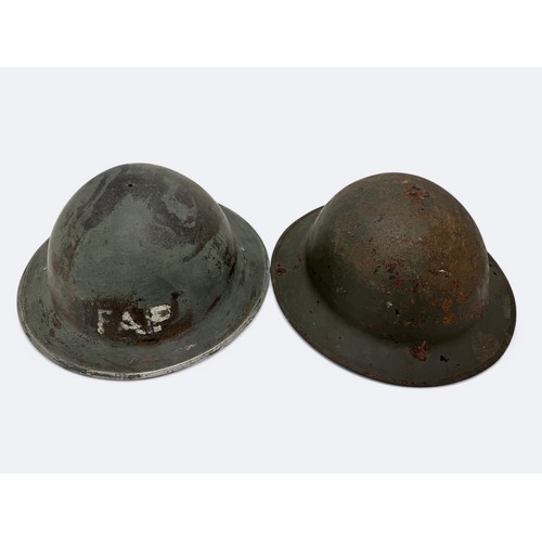 114 - Two WWII Home Front helmets. A First Aid Party non-magnetic helmet missing strap and liner, and a ma... 