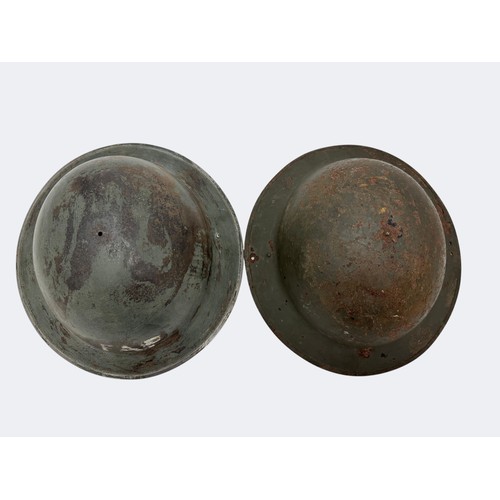 114 - Two WWII Home Front helmets. A First Aid Party non-magnetic helmet missing strap and liner, and a ma... 