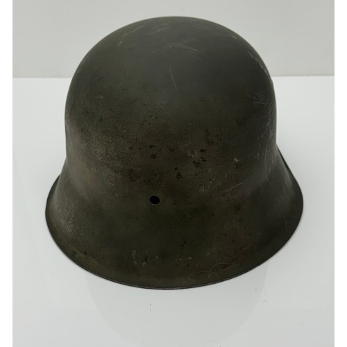 68 - A WWII Third Reich M42 steel helmet, marked CKL 64 (C and K very indistinct). Repainted