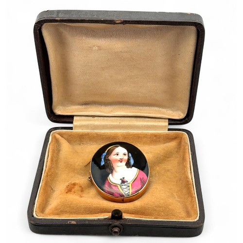 56 - A brooch set with a painted porcelain portrait of a young girl, mount stamped 15ct. length 36mm.