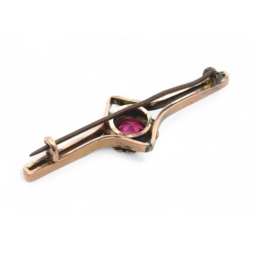 10 - A ruby and pearl cluster bar brooch, approx length 5cm. Base metal pin. Tested as 9ct gold using XRF