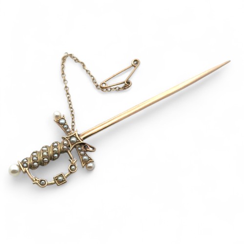 22 - A yellow metal and seed pearl tie pin in the form of a sword, with safety chain. Length approx 8cm. ... 