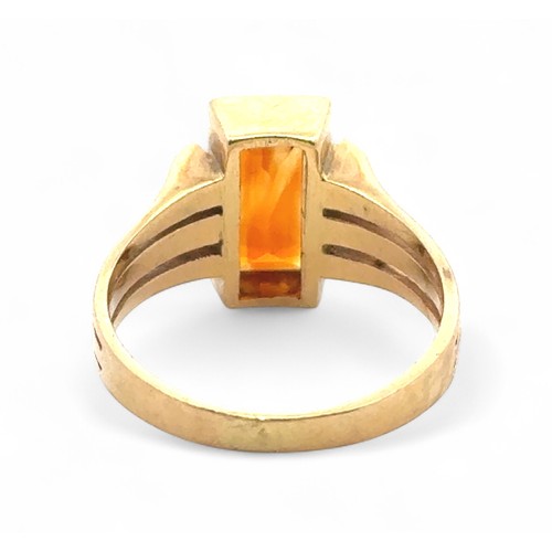 4 - A rectangular citrine ring, bezel set in a yellow metal mount stamped 750, size  N. 5.11g