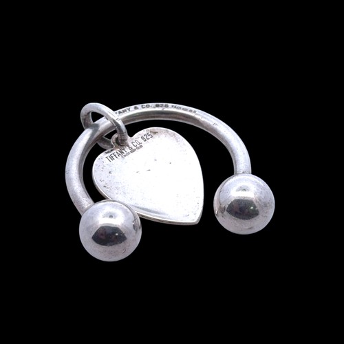 39 - Tiffany & Co -  A silver key ring holder wit heart shaped tag, complete with a box and pouch.