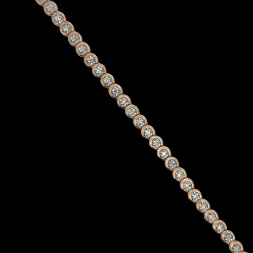 52 - A 9ct gold and illusion set diamond tennis bracelet, stamped 375 and CCM mark, sponsor SG. Approx 18... 