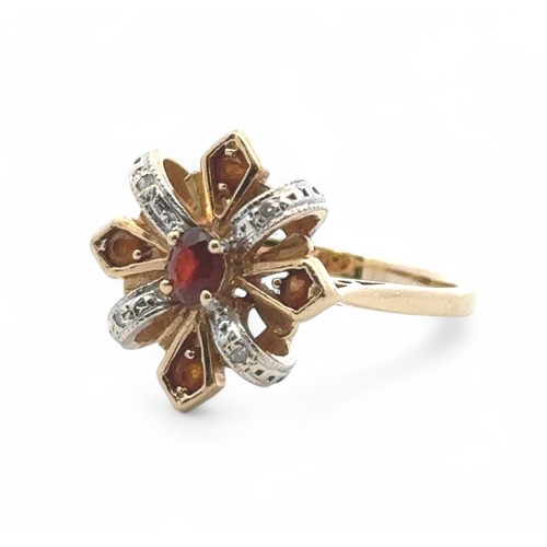 21 - A garnet, citrine and diamond ring in 14ct yellow gold. Size N.