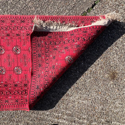 A long Afghan Mauri runner rug with Bokhari design, deep red ground ...
