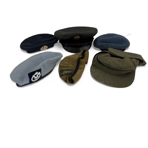 106 - Range of six military caps, some with badges etc.
