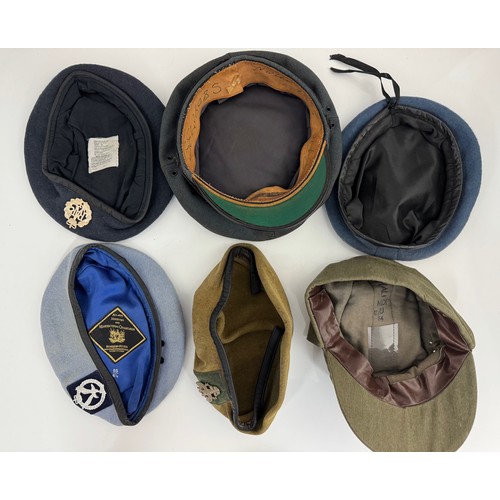 106 - Range of six military caps, some with badges etc.