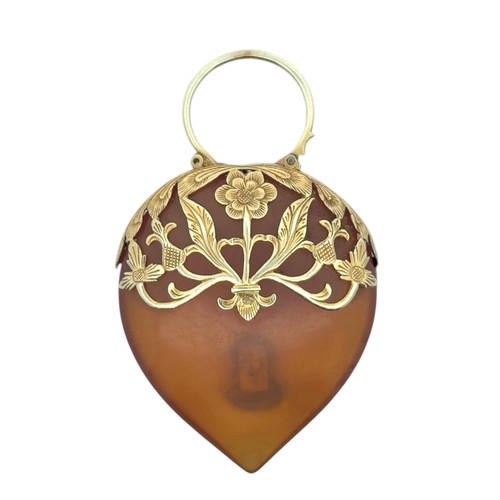 32 - A pear-shaped tortoiseshell pendant with unmarked yellow metal openwork mount tested as gold (approx... 