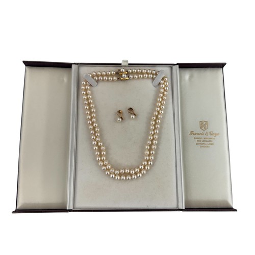 30 - A double strand uniform cultured pearl necklace with an 18ct yellow gold and diamond clasp. Can be d... 