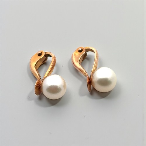 30 - A double strand uniform cultured pearl necklace with an 18ct yellow gold and diamond clasp. Can be d... 