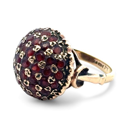 44 - A garnet bombe ring set in 9ct gold, size J/K.