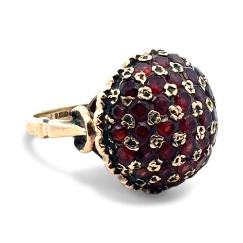 44 - A garnet bombe ring set in 9ct gold, size J/K.