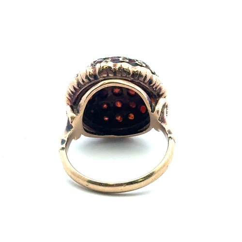 44 - A garnet bombe ring set in 9ct gold, size J/K.