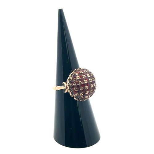 44 - A garnet bombe ring set in 9ct gold, size J/K.