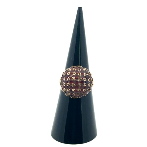 44 - A garnet bombe ring set in 9ct gold, size J/K.