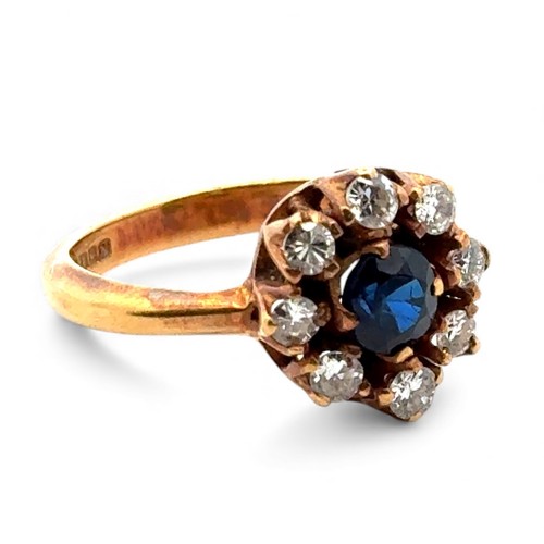 5 - An 18ct sapphire and diamond cluster ring, size L.  The sapphire approx 4.6mm. Estimated diamond wei... 