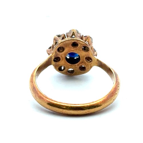 5 - An 18ct sapphire and diamond cluster ring, size L.  The sapphire approx 4.6mm. Estimated diamond wei... 