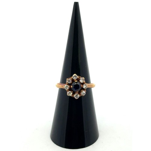 5 - An 18ct sapphire and diamond cluster ring, size L.  The sapphire approx 4.6mm. Estimated diamond wei... 