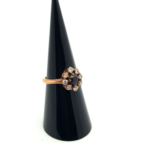 5 - An 18ct sapphire and diamond cluster ring, size L.  The sapphire approx 4.6mm. Estimated diamond wei... 
