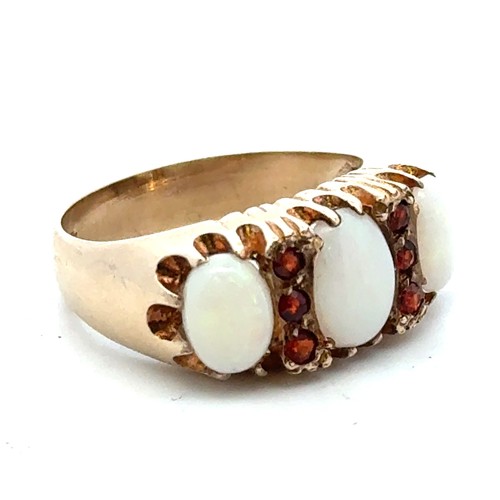 25 - A 9ct gold, opal and garnet ring, size O.