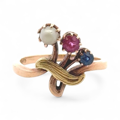 21 - An unusual ruby, sapphire and white stone ring, stamped 585. size J.