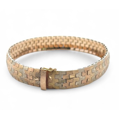 2 - A tri-coloured and engraved gold bracelet stamped 750. Length 19cm.