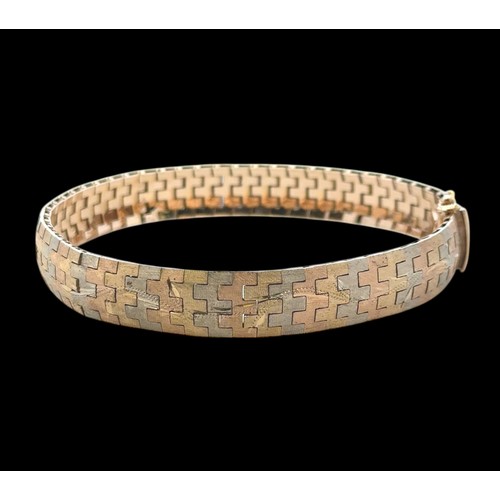 2 - A tri-coloured and engraved gold bracelet stamped 750. Length 19cm.