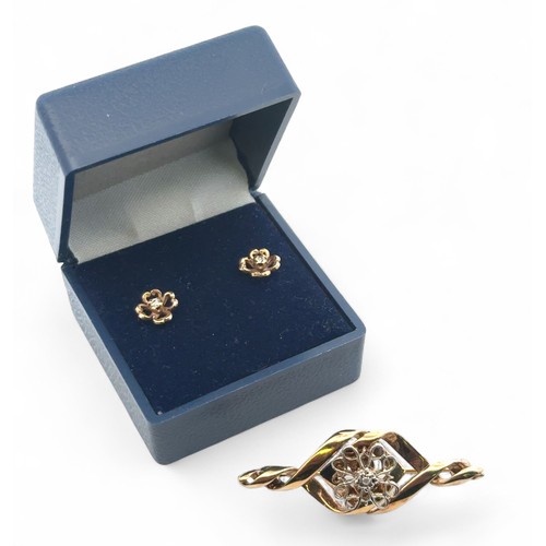 55 - A 9ct yellow gold  brooch with central white gold knot set with a small diamond 42mm length, togethe... 