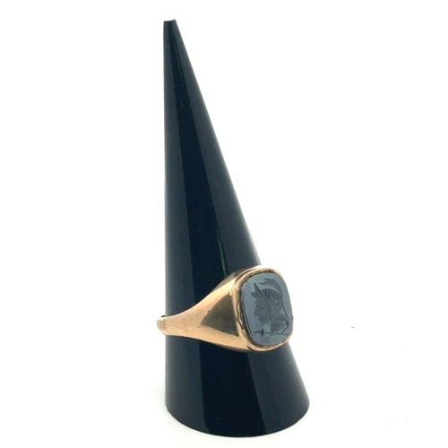 4 - A haematite centurion intaglio signet ring in 9ct yellow gold, size U.