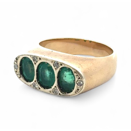 3 - A three stone emerald ring with diamond, size M. Emeralds each approx 6mm x 5mm. Unmarked yellow met... 