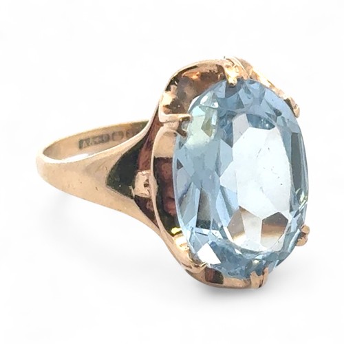 47 - A 9ct gold and oval blue synthetic spinel ring, size N. 3.26g