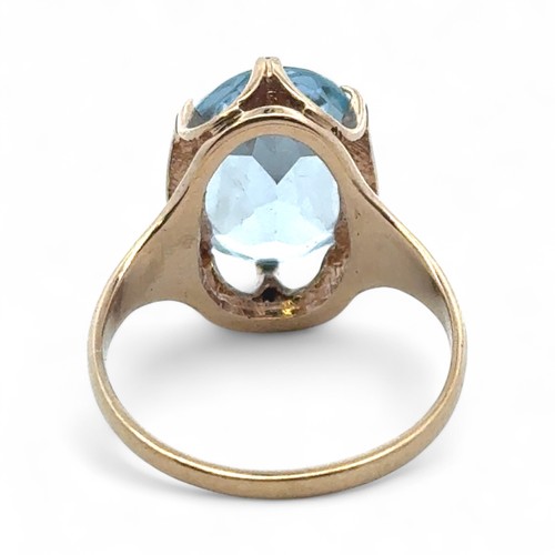 47 - A 9ct gold and oval blue synthetic spinel ring, size N. 3.26g