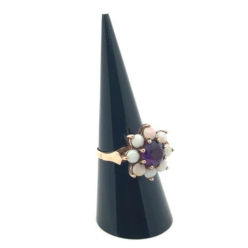 6 - An amethyst and opal stone cluster ring, stamped 9ct gold, size M.