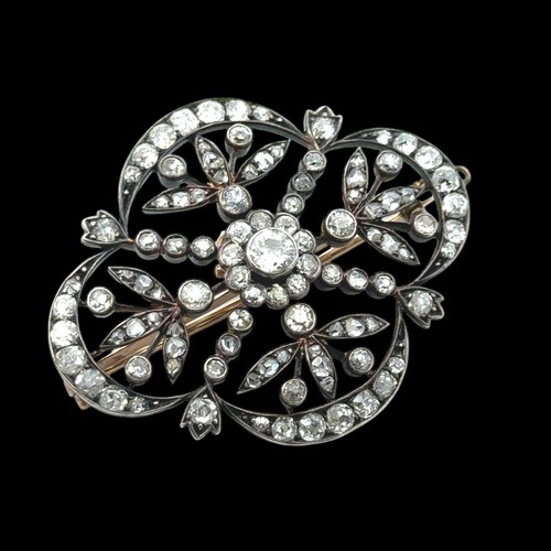 12 - A Victorian diamond brooch of quatrefoil openwork form with floral motif. The old cut diamonds (with... 