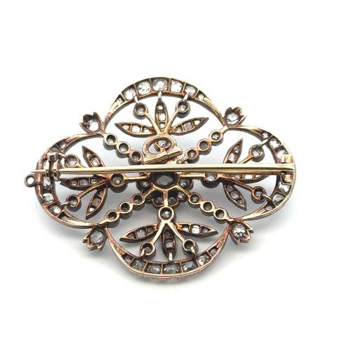 12 - A Victorian diamond brooch of quatrefoil openwork form with floral motif. The old cut diamonds (with... 