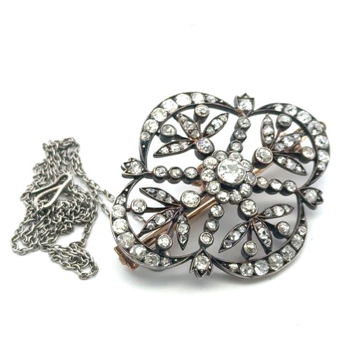 12 - A Victorian diamond brooch of quatrefoil openwork form with floral motif. The old cut diamonds (with... 