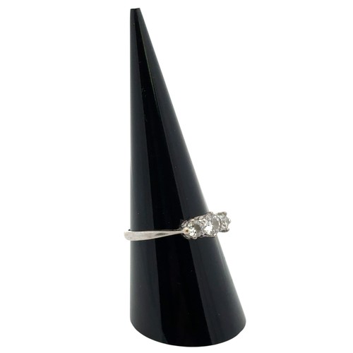 56A - A three stone diamond ring in unmarked white metal, tested as 18ct gold. Estimated diamond weight ap... 