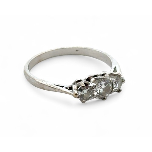 56A - A three stone diamond ring in unmarked white metal, tested as 18ct gold. Estimated diamond weight ap... 