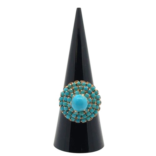 3 - A turquoise cluster set dress ring stamped 750, size Q. 5.83g