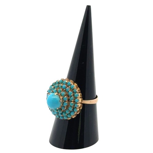 3 - A turquoise cluster set dress ring stamped 750, size Q. 5.83g