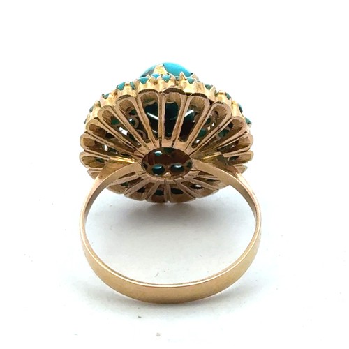 3 - A turquoise cluster set dress ring stamped 750, size Q. 5.83g