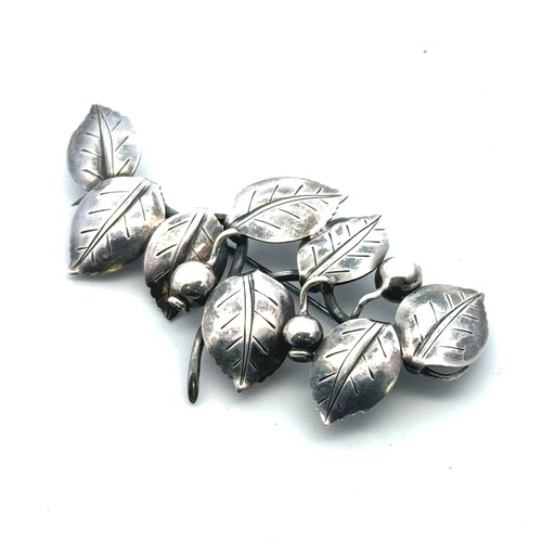 32 - Anton Michelsen -  a Danish silver brooch in the form of leaves and berries, with makers mark to rev... 