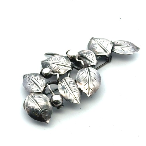 32 - Anton Michelsen -  a Danish silver brooch in the form of leaves and berries, with makers mark to rev... 