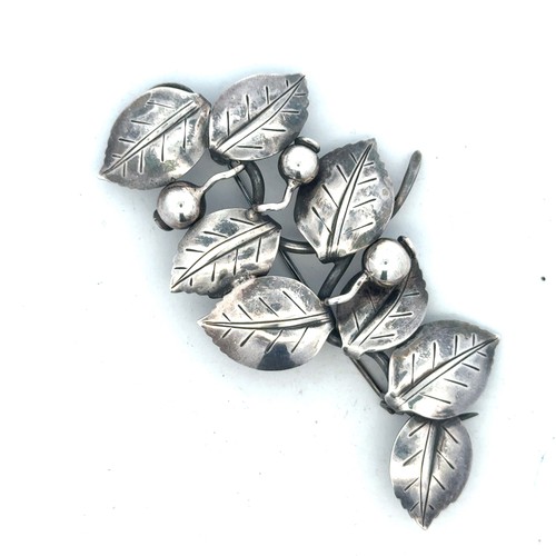 32 - Anton Michelsen -  a Danish silver brooch in the form of leaves and berries, with makers mark to rev... 