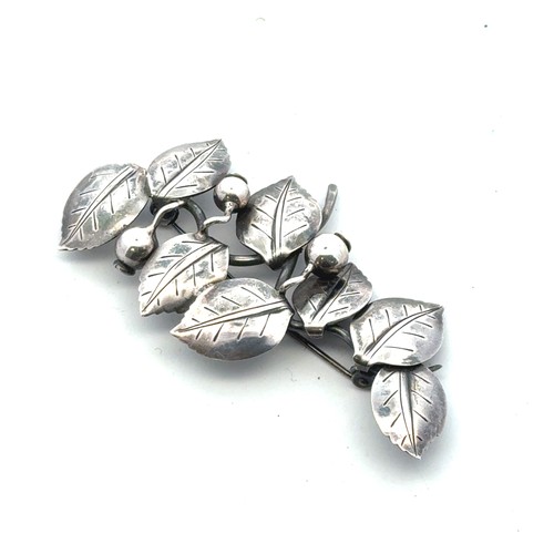 32 - Anton Michelsen -  a Danish silver brooch in the form of leaves and berries, with makers mark to rev... 