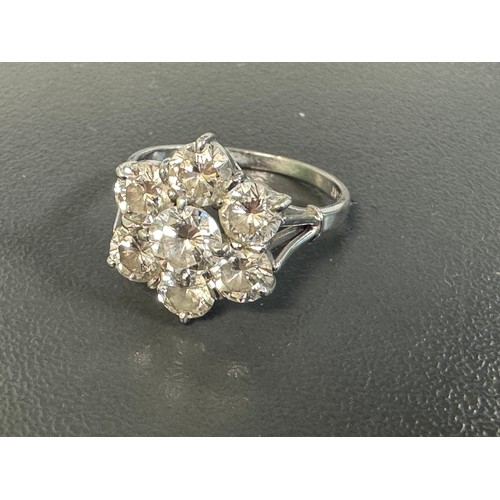 9 - A diamond cluster flower ring in a white metal mount stamped 18ct and platinum. Size P. Total estima... 